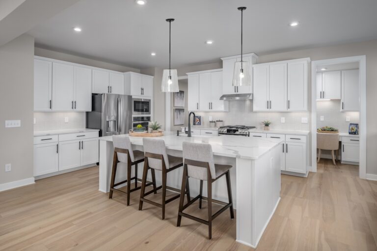 Stunning Eat-In Kitchen with Bar Stools in Sleek White, Neutral, Normady Model at Forest View | Pittsburgh New Home Connection