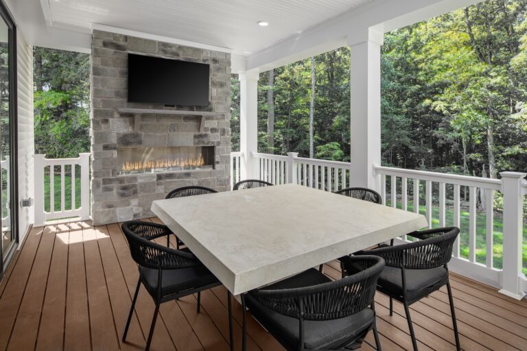 Stunning Covered Porch with Outdoor Gas Fireplace & TV and Dining Area with View in Santorini New Home at Pinewood | Pittsburgh New Home Connection