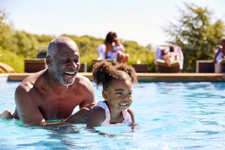 Grandfather Teaching Granddaughter to Swim in Outdoor Pool at Willowbrook Ranch New Home Community | Pittsburgh New Home Connection